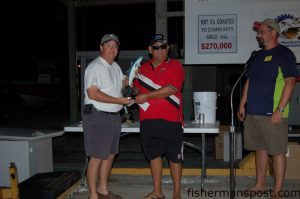 Jim Inman accepts the second place trophy and check for over $18,000 in the Sneads Ferry King Mackerel Tournament. LIke the winners, Inman and Tim Newton, fishing aboard the "Deal King," found their valuable mackerel at the 1700 Rock.