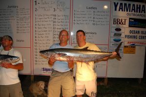 Keith Logan and Tracy Holmes hold the 36.65 lb. king mackerel that earned them the first place spot in the Jolly Mon King Classic after the disqualification of the previous winner. The king fell for a horse ballyhoo at the General Sherman.