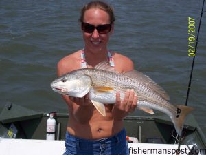 Michelle Marshburn with a red drum taken behind Bald Head Island.