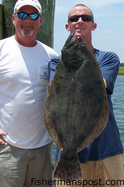 Capt Chad Casteen, of Southport Angler Outfitters, and Allen Beasley with an 8 lb. 6 oz. flounder caught in the Cape Fear River on a mullet minnow.