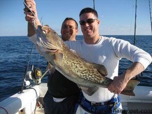 Nick Freeh (age 9), from Holly Springs, with a red drum caught on a Calcutta Flashfoil while fishing from the surf of Wrightsville Beach with Capt. Danny Wrenn of 96 Charter Company.