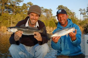 Gary Hurley and Capt. Ricky Kellum with a pair of speckled trout just prior to their tagging and healthy release. Both fish fell for pink soft plastic shrimp in a creek off the New River near downtown Jacksonville.