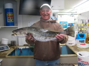 Mac McIntosh with the 6.84 lb. speckled trout that took first place in the first annual Chasin Tails Speckled Trout Challenge. McIntosh hooked the fat trout on a green/white MirrOlure in a creek off the Neuse River.