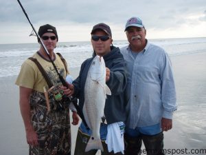 Sam Ray, from Haw River, NC, with his first red drum, caught from the surf at Topsail.