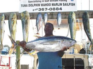 Eddie Green, from Fort Bragg, NC, with a 38.8 lb. yellowfin tuna he hooked on a ballyhoo under a blue/white Mylar Cape Fear Sea Witch. He was trolling near the Same Ol' with Capt. Keith Green and mate Charlie Beal aboard the charter boat "Fish Dance" out of Carolina Beach.