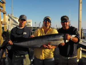 Scott Aldridge, Clifton Watson, and Todd Jones with a 74 lb. wahoo they hooked at the Steeples on a ballyhoo under a red/black Ilander. They also caught a smaller 'hoo and a quartet of blackfin tuna while trolling aboard the "Bar Pirate."