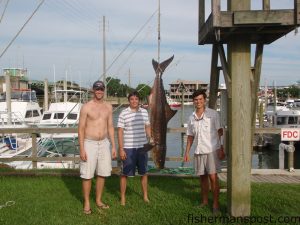 Kevin Branch, Carlton Price, and Harrison Masters, from Lumberton, NC, with a 67 lb. cobia Masters landed on a flounder setup after an hourlong fight at the Masonboro Jetties.