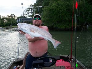 Kenny Shepard with a 27", 9 lb. puppy drum he hooked underneath a dock in Pages Creek on a live finger mullet.