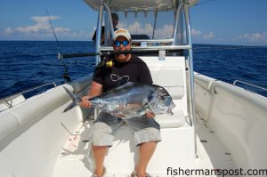 Capt. Chesson O’Briant, of CXC Charters, with the African pompano he hooked while dropping a cigar minnow-tipped bucktail 150’ down to AR 302. He landed the fish after a dogged 15 minute battle. 