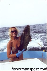 Anakalea Waldorf, a Wilmington local working at Island Tackle and Hardware, with a grouper caught off of Carolina Beach. She was fishing with Capt. Caleb Batson on the charter boat "Cheerio Lady."