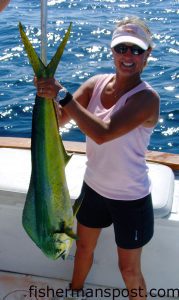 Melinda Hicks, from Charlotte, NC, with a dolphin she hooked on a small ballyhoo while trolling offshore of Southport with Capts. Butch and Chris Foster of Yeah Right Charters.