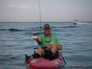 Gary Hurley with a threadfin herring he snagged with a Gotcha plug while jigging at the Masonboro jetties out of a Hobie Mirage Revolution.