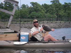 Michael Garet, of Hobie Kayaks, with a keeper flounder he hooked on a Gulp bait in Hewlett's Creek while fishing out of his Mirage Revolution.