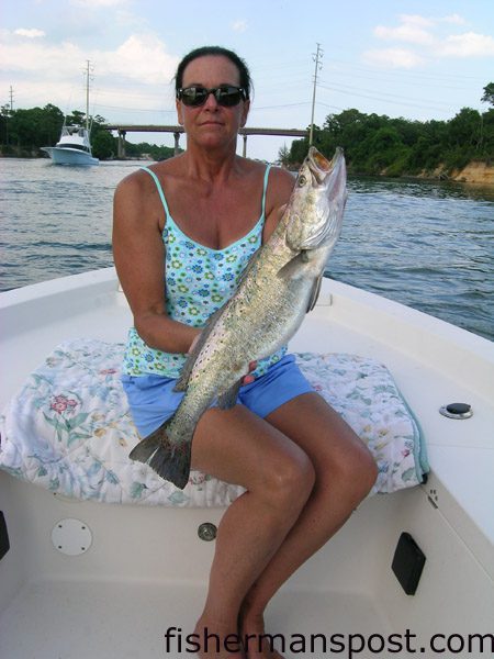 Candace Wooten, from Wilmington, NC, with a 5 lb., 9 oz. citation speckled trout she hooked on a  live pogy in Snow’s Cut while fishing aboard the “HyperActive.”