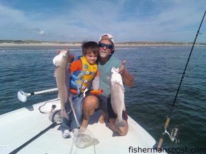 Tim Ludlum, of Wilmington, and his grandson Xander Lamm, of Smithfield with red drum they hooked at New River Inlet on a new penny Gulp shrimp.