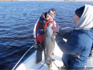 Jeffrey Byrd with a 31" striped bass he hooked in the Cape Fear River while fishing with his dad, Todd, and Duane Auman.