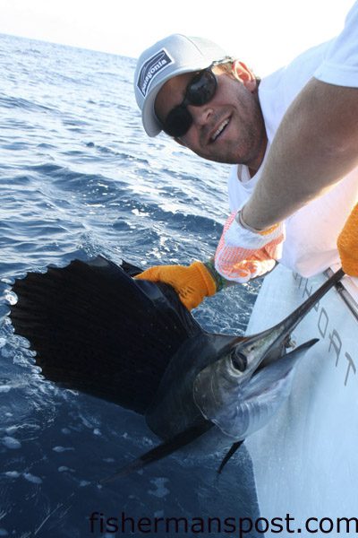 Judson Brock, of Topsail Beach, with a sailfish that bit a blue-skirted ballyhoo while he was trolling in 16 fathoms off Masonboro Inlet with Will Coleman, Andrew Cooper, and Kenan Brock. Photo courtesy of Chandler Hatch with Hatch Photography.