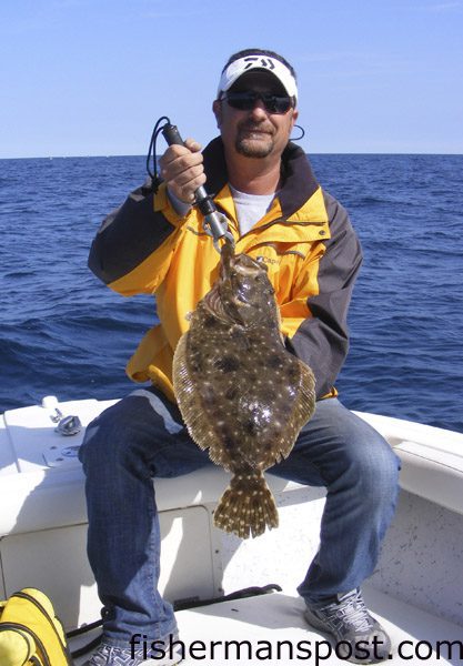 Capt. Chris Kimrey, of Mount Maker Charters, with a fat flounder he caught on a hand-tied 2 oz. bucktail tipped with a Gulp bait while fishing some structure off Beaufort Inlet in 70′ of water.