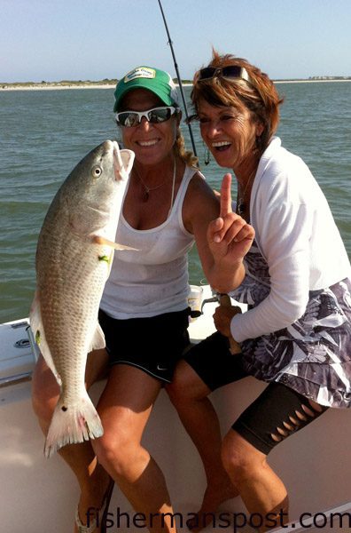 Leila Tabatabai, of Wilmington, and GiGi Gelinas, of Quebec, Canada, with a 27″ red drum that bit a cut bait in Carolina Beach Inlet.