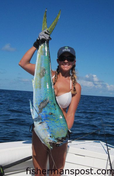 Heather Williamson, of Wrightsville Beach, with a dolphin that she hooked 30 miles off Masonboro Inlet while fishing with Dave Moore and David Duke.