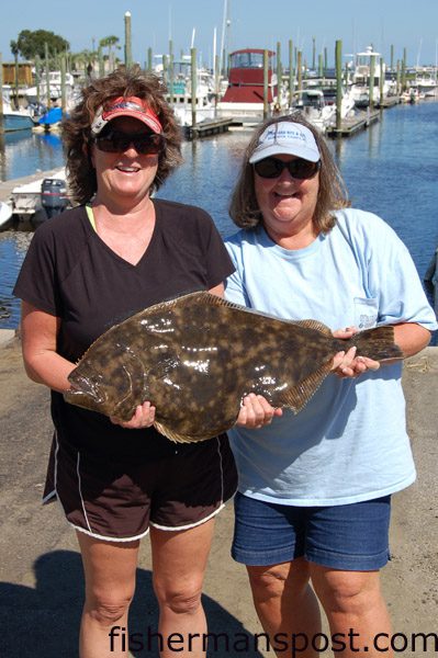 DeeDee Creech and Teresa Fulford with the huge 11.02 lb. flounder that earned they and their husbands–the “Flounder Nuts”–the flatfish title at the North Carolina Inshore Championship. Creech hooked the fish in 16′ of water in Snow’s Cut on a live finger mullet.