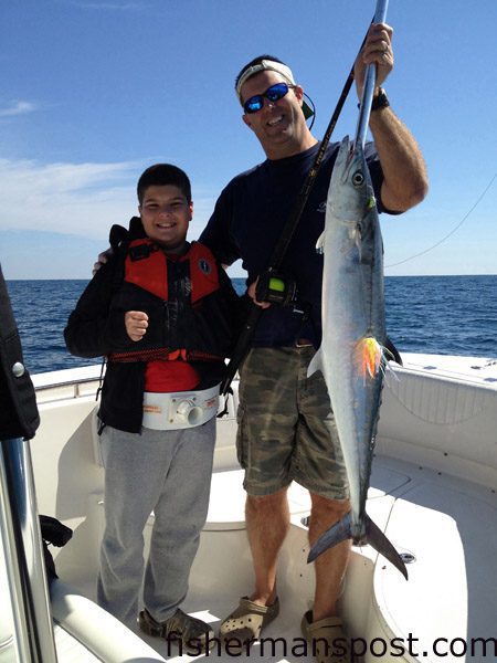 Jay and Jack (age 10) Flanary, of Sanford, NC, with Jack’s first king mackerel, a 35″ fish that bit a dead northern mackerel 12 miles off New River Inlet.