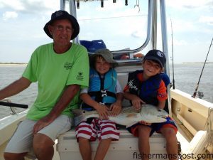 Hamilton and Hark Vaughan, of Raleigh, NC, with a red drum that bit a large live mullet at the east end of Ocean Isle Beach.