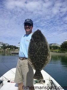 David Robinette, of Reidsville, NC, with a 7 lb. flounder he hooked on a live finger mullet near Mason's Inlet.