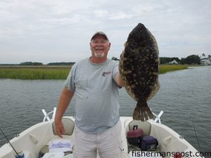 Jon Faussett with a 7 lb., 14 oz. flounder that bit a live finger mullet in the Lockwood Folly River near Varnamtown while he was fishing with Pete Enis.