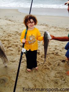 Ivy Blevins with her first puppy drum, hooked in the Hatteras Village surf. Photo courtesy of The Roost Bait and Tackle.