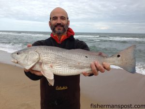 Walter Mizelle, of Charlotte, NC, with a puppy drum that bit a cut bait near the Buxton jetties while he was fishing with college friends from Western Carolina University.