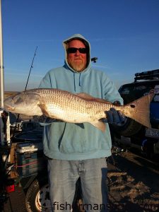 Vick Radford with a 30" red drum he caught and released in the Fort Fisher surf after it fell for a chunk of salted mullet.