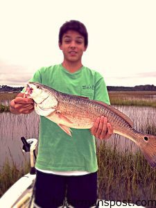 Gavin Tippett, of Kernersville, NC, with a red drum that fell for a live mullet in the sound behind Atlantic Beach.