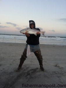 Brandon Cartrette, of Leland, NC, with a 26.5" red drum that he hooked on a chunk of mullet while surf fishing the north end of Carolina Beach.