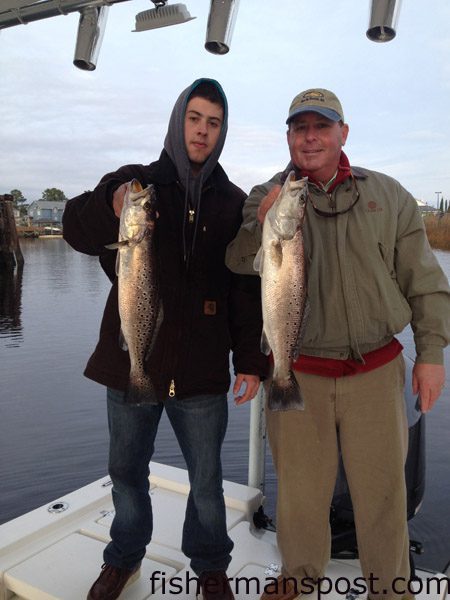 Kenny and Peyton Smith with a pair of speckled trout that bit D.O.A. and VuDu shrimp lures near Little River while they were fishing with Capt. Mark Dickson of Shallow Minded Inshore Fishing Charters.