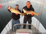 Benny Trujillo, of Houston, TX, and Rey Cirino, of Ft. Bragg, NC, with a pair of red drum they hooked in some shallow water off the New River while fishing with Capt. Allen Jernigan of Breadman Ventures. The reds fell for TTF Killer Falts Minnow soft plastics scented with Pro-Cure.