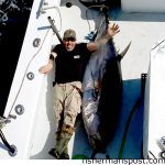 Kevin Eller and a 96", 308 lb. dressed weight bluefin tuna that attacked a skirted ballyhoo off Oregon Inlet while he was trolling with Capt. Lee Collins on the "Strike 'Em" out of Oregon Inlet Fishing Center.