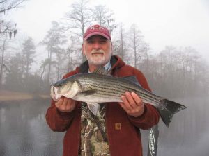 Donald Lilly, of Vanceboro, NC, with a Neuse River striped bass that fell for a D.O.A. CAL soft plastic while he was fishing with Capt. Gary Dubiel of Spec Fever Guide Service.