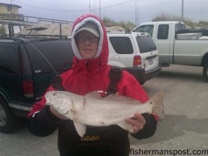 Jake Worthington (age 15), of Camden, NC, with a puppy drum he hooked in the Frisco surf.