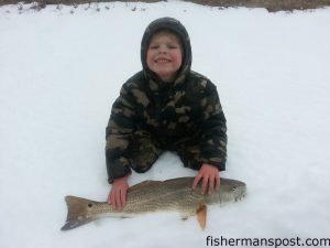 Liam Van Druten with a puppy drum he hooked in the Frisco surf while fishing with his father. Photo courtesy of Frisco Rod and Gun.