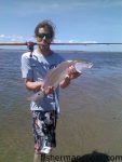 Zach Diamond, of Kill Devil Hills, NC, with a slot red drum that he hooked while fishing Oregon Inlet with Rachel Marshall. Photo courtesy of TW's Tackle.