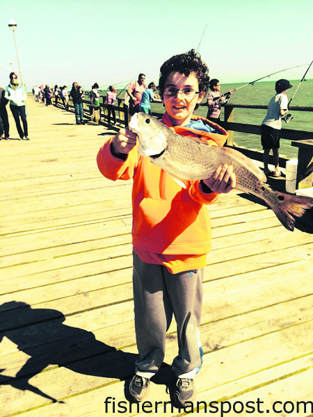 Tommy Dale, of Horseheads, NY, with a 19″ red drum that bit cut shrimp off Kure Beach Pier.