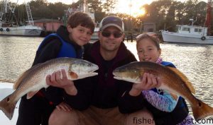 Alex (age 8), Mark, and Cameron (age 9) Wood, from Raleigh, with some slot red drum they hooked on live mud minnows while fishing the Shallotte River with Capt. Jacob Frick of J&J Inshore Charters.