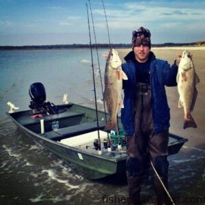 Marcus Denning with a pair of 26" red drum out of 50+ he and his father caught on Zoom Fluke soft plastics in the surf around Bogue Inlet.