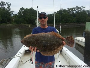 Tony Del, of A&M Screenprinting in Wilmington, with a flounder he hooked at some nearshore structure off Wrightsville Beach on a Gulp-tipped bucktail.