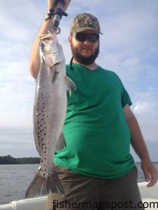 Joe Badger, of Ash County, NC, with a fat speckled trout that bit a live menhaden near Holden Beach while he was fishing with Capt. Kevin Sneed of Rigged and Ready Charters.