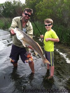 Matthew McIver, of Wilmington, and his cousin David Lashley (age 8), of Cary, NC, with a 30" red drum that bit a frozen mud minnow in the Cape Fear River near Carolina Beach.