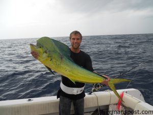 Hunter Kailos with a bull dolphin that bit a black/yellow/clear trolling plug 57 miles off Masonboro Inlet while he was fishing with Clint Cornette.