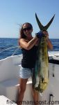 Nicole St. Cyr, of Southport, with a 26 lb. dolphin she hooked while trolling 60 miles off Bald Head Island with Patrick Jones and Andy and Boyce Broadwell on the "Nauti Lady."