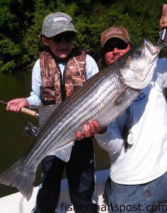 Gracie Davis (age 10) and Capt. Richard Andrews, of Tar-Pam Guide Service, with a 22 lb., 38" striped bass Gracie caught while fishing the Roanoke River near Weldon.